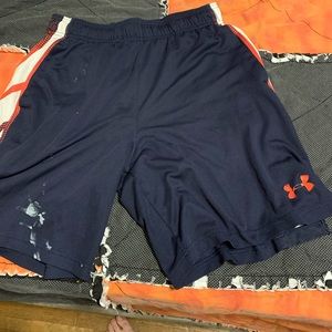 Navy blue and red Under-armor basketball shorts. Paint stain on lower left part.
